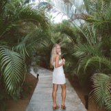 Jordan walking down a path in a tropical place.