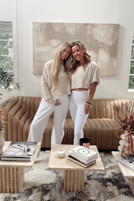 Jordan from The Balanced Blonde and her mom standing in her bright living room.